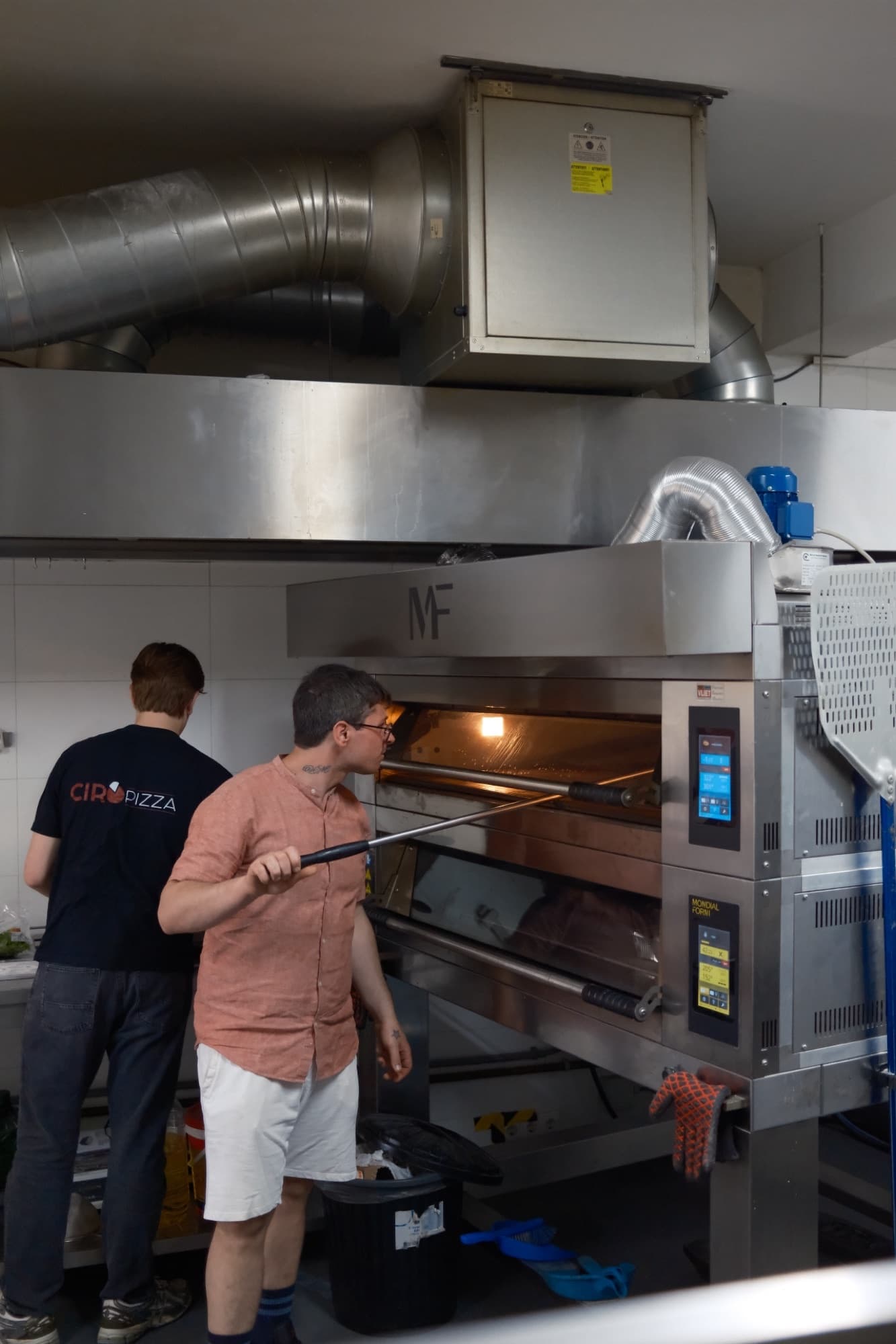 Vincenzo working at the deck oven inside Ciro Pizza